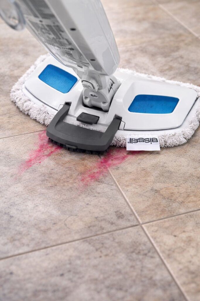 team mop scrubber lifting dried-on food and sticky spills from tile floor