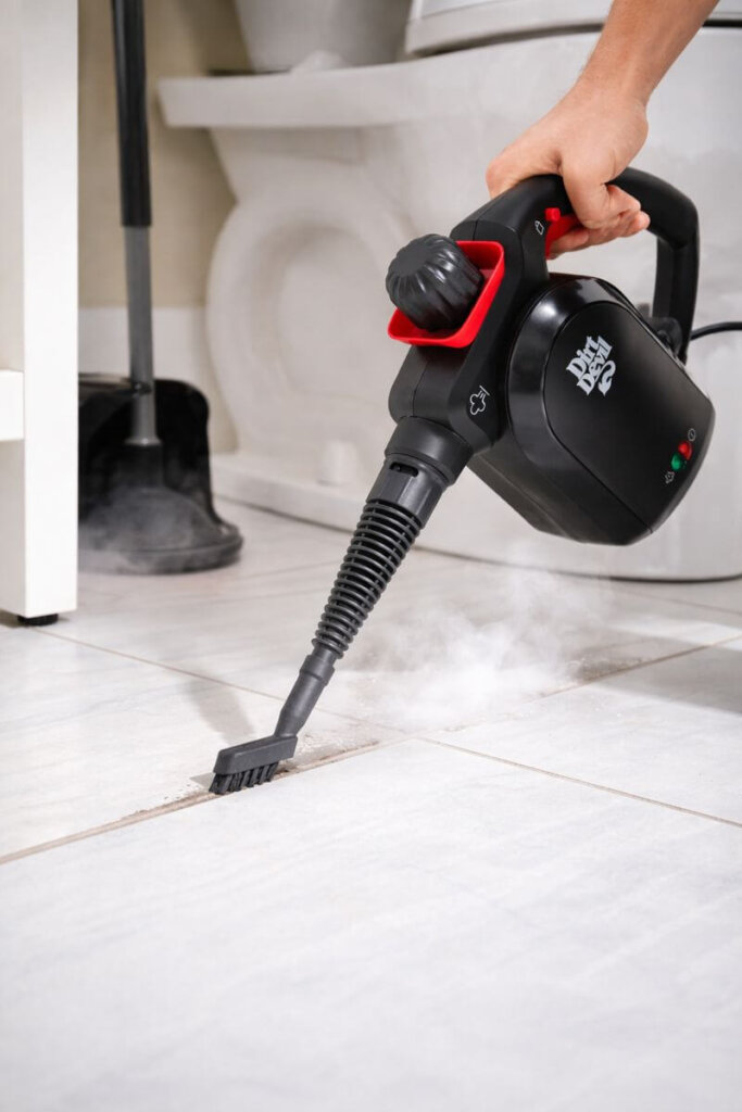 Dirt Devil 7-in-1 handheld steam cleaner using precision nozzle to clean grout lines and tight corners