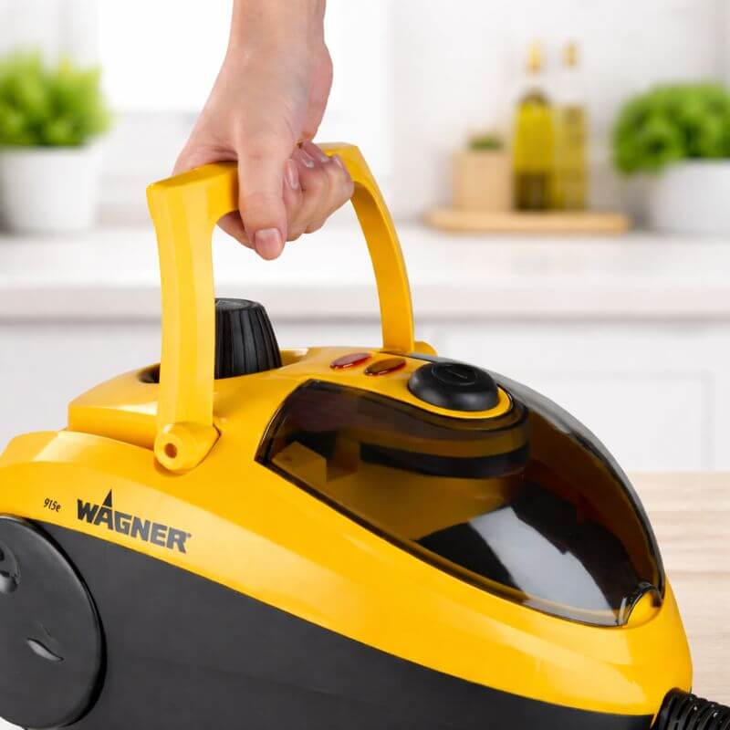Wagner Spraytech 905e steam cleaner showing the integrated carry handle being held for easy portability
