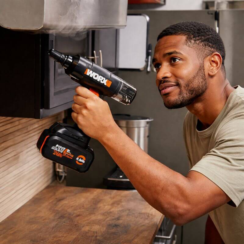Using the compact and lightweight Worx 20V SteamStorm handheld steam cleaner to clean kitchen surfaces