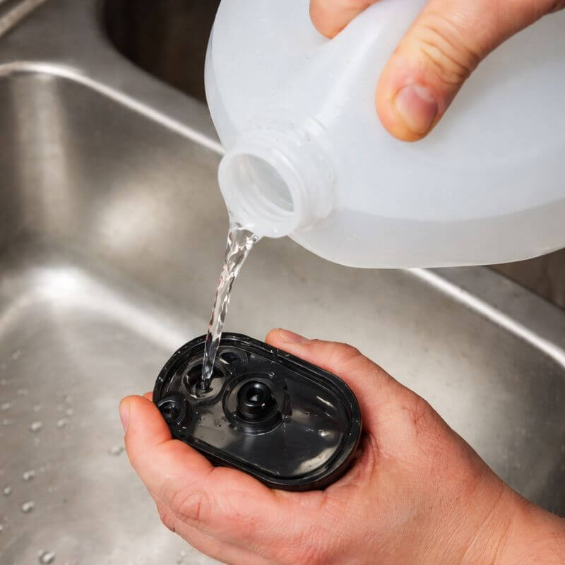 Filling the water tank of the Worx 20V SteamStorm steam cleaner with plain water for 100% chemical-free cleaning