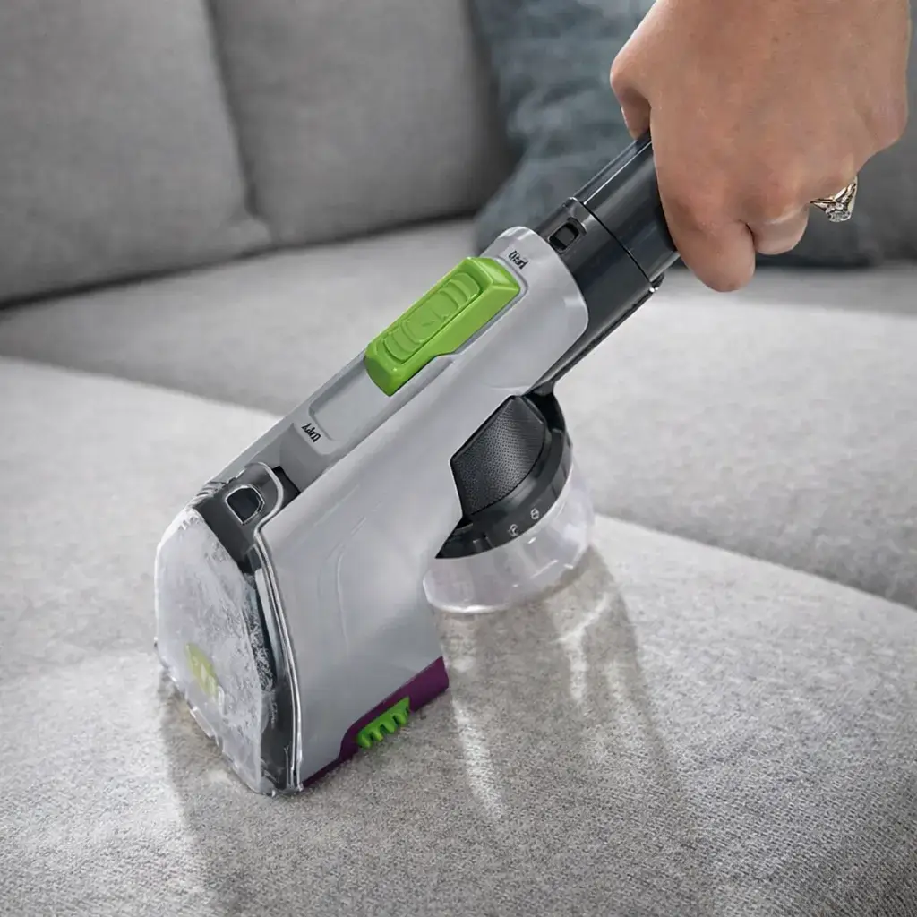 Bissell Revolution HydroSteam Pet 3432 using pet tool to deep clean upholstery and stairs.